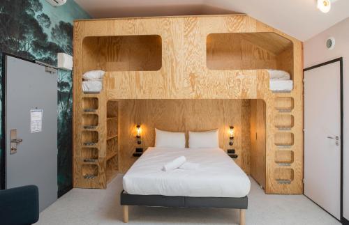 a bedroom with a bed with a wooden bed frame at Eklo Bordeaux Centre Bastide in Bordeaux