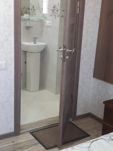 a bathroom with a sink and a shower backdoor at Apartments on Akhalubani St 2 in Tbilisi City