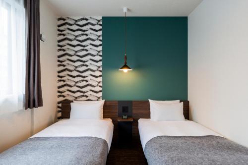 Postel nebo postele na pokoji v ubytování M's Hotel Gojo Odawara