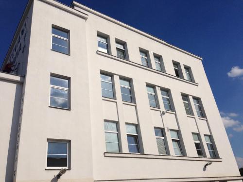 a white building with windows on the side of it at Hostel BOHEMIA in Prague