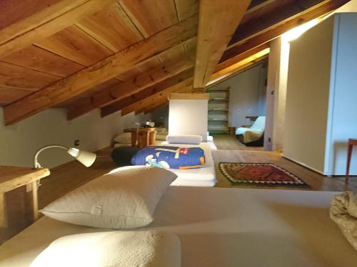 a bedroom with a bed in a room with wooden ceilings at Chalet Morier in Demonte