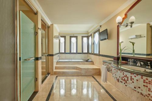 a bathroom with a tub and a sink at Park Regency Sharm El Sheikh Resort in Sharm El Sheikh