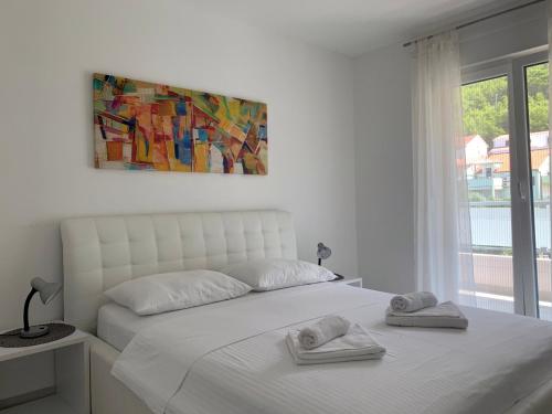 Ένα ή περισσότερα κρεβάτια σε δωμάτιο στο Apartments Danica