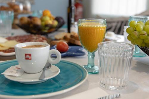 a table with a cup of coffee and a glass of wine at Hostal Boutique Olvido 22 Adults Only in Peñíscola