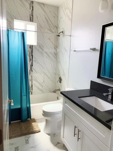 a bathroom with a toilet and a sink and a shower at Modern Hostel address changed in Los Angeles