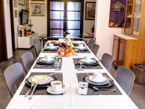 a long table with plates and bowls of food on it at Antichi Ricordi in Aci SantʼAntonio