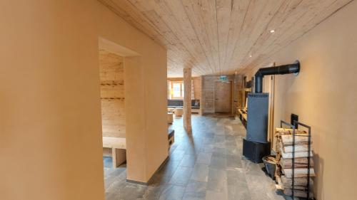 a room with a wooden ceiling and a fireplace at alpen select lodge Kleinwalsertal in Riezlern