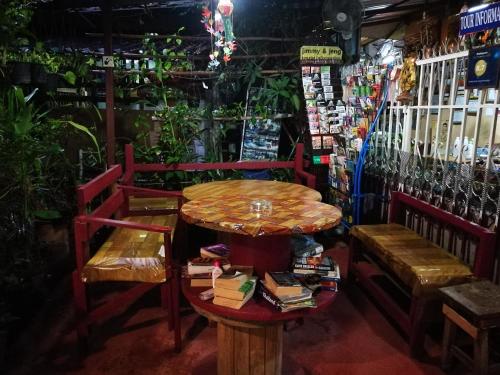 a table and two benches and a table and chairs at Jimmy and Jeng Homestay in Chiang Mai