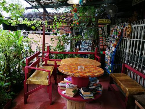 a table and a bench and a table and books at Jimmy and Jeng Homestay in Chiang Mai