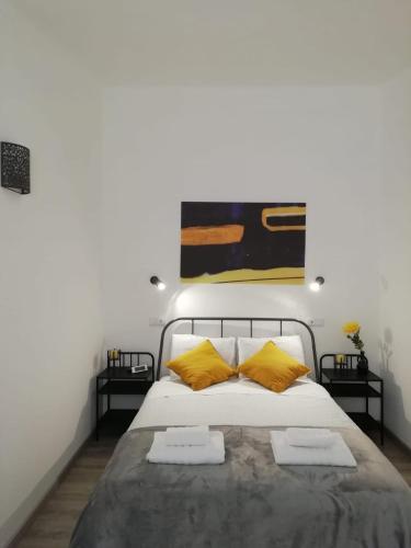 a bedroom with a bed with two yellow pillows at Lagos Central Apartments Ap 14 in Lagos