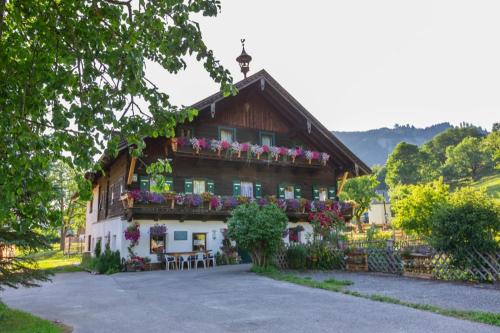 a house with flowers on the side of it at Haus Unterdorf in Goldegg