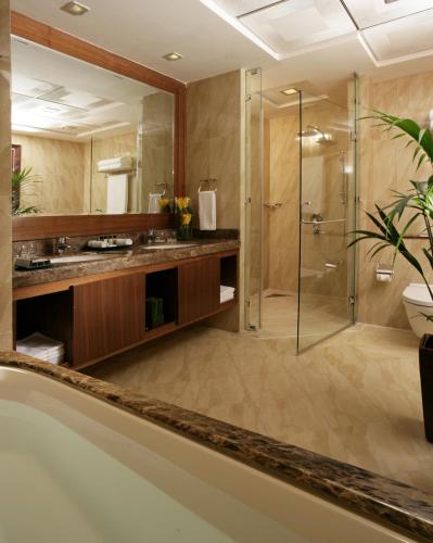 a bathroom with a glass shower and a sink at La Suite Dubai Hotel & Apartments in Dubai