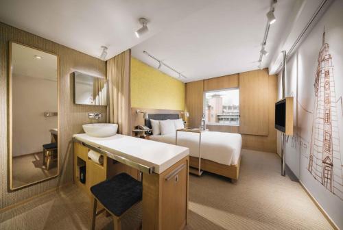 a hotel room with a bed and a sink at Eaton HK in Hong Kong