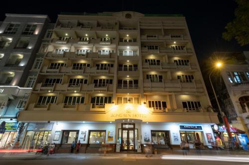 a building on a street at night at Bong Sen Hotel Saigon in Ho Chi Minh City