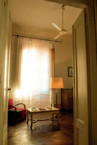 a living room with a table and a window at Le Tre Stanze in Florence