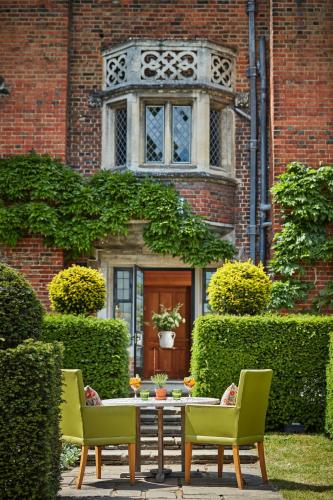 a table and chairs in front of a building at Great Fosters - Near Windsor in Egham