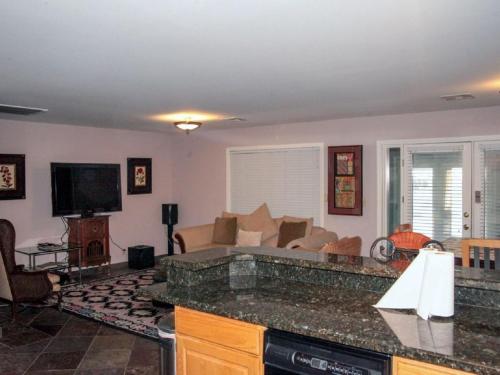 a kitchen with a living room with a couch at Villa Caridad in Las Vegas