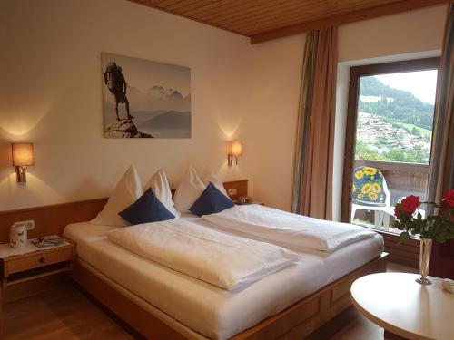 a hotel room with a bed and a window at Apartments Haus Huber in Mühlbach am Hochkönig