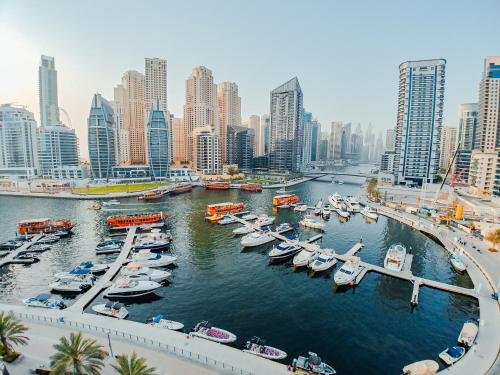 a group of boats docked in a harbor in a city at Signature Hotel Apartments and Spa in Dubai