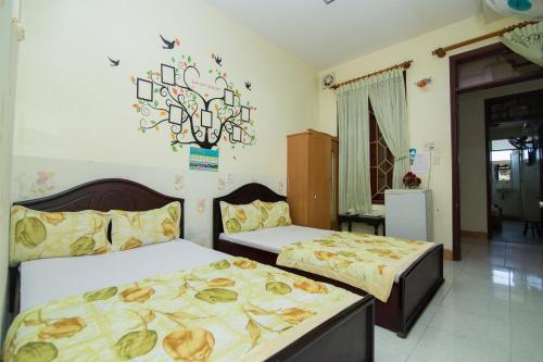 a bedroom with two beds and a chandelier at Hung Dong Hotel in Quy Nhon