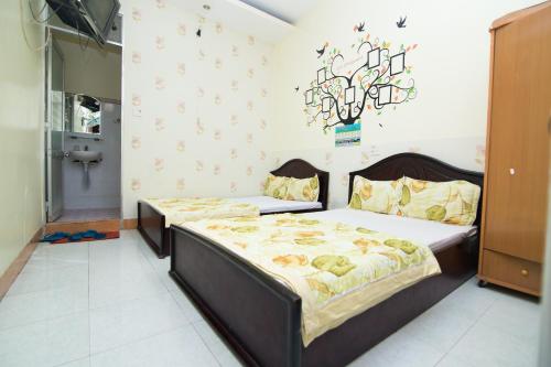 a bedroom with a bed and a chandelier on the wall at Hung Dong Hotel in Quy Nhon