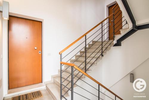 a staircase with a wooden door in a house at YPApartments FIERA in Padova