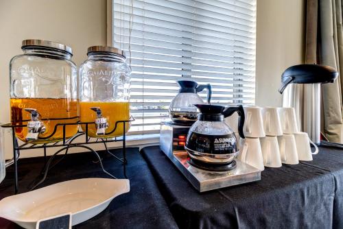 a table with three glass vases on it at Parkview On Hagley in Christchurch