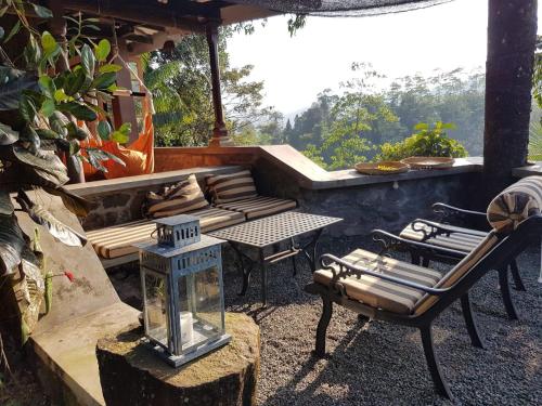 a patio with a couch and a table and chairs at Singharaja Garden AGRO ECO Lodge in Pelawatta