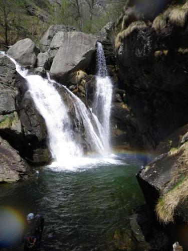 a waterfall in a pool of water in a river at La Casetta nel cuore del Parco in Locana