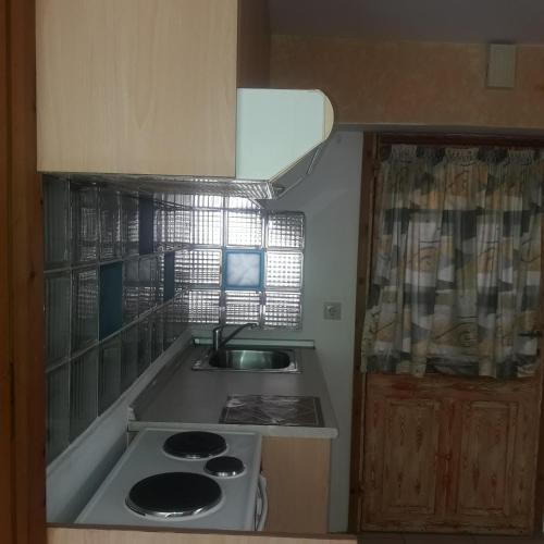 a small kitchen with a sink and a stove at Ground Floor Studio Galini in Rethymno