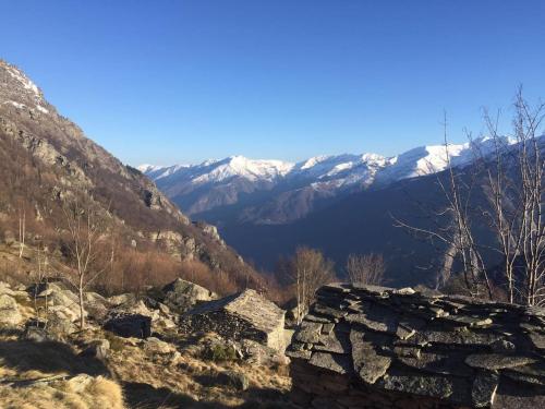 a view of a mountain range with snow covered mountains at La Casetta nel cuore del Parco in Locana