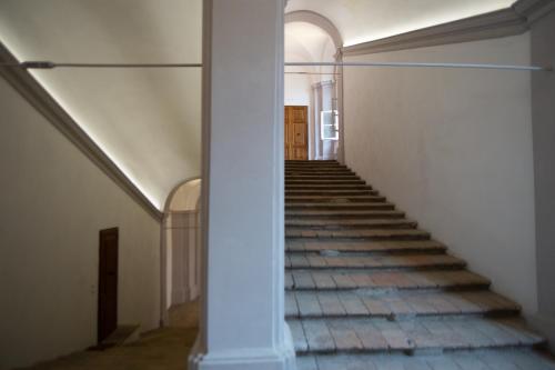 a stairway in an old building with a column at Santa Cecilia Perugia - Rooms&Suite in Perugia