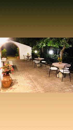 an outdoor patio with tables and chairs and lights at Podere Casa Bianca in Santa Luce