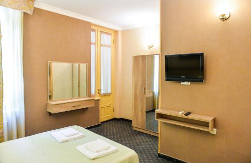 a hotel room with a mirror and a television at Hotel Old Town in Kutaisi
