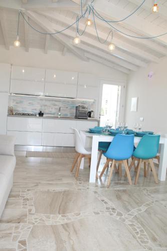 a kitchen and dining room with a table and chairs at R House Budoni in Budoni