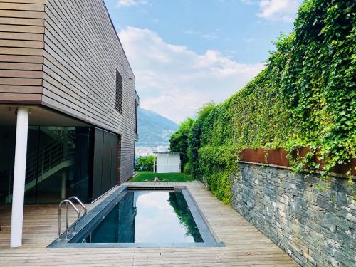 a house with a swimming pool next to a building at Casa Sull'Albero in Malgrate