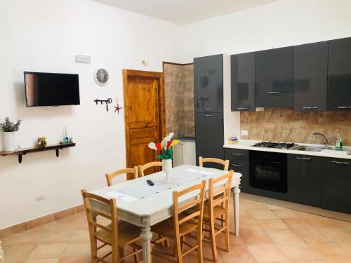 cocina con mesa y sillas en Appartamento Renis en Sant'Isidoro