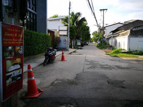 a street with orange cones and a motorcycle parked on the street at Jimmy and Jeng Homestay in Chiang Mai