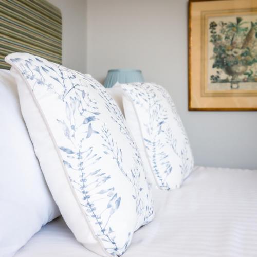 two white pillows sitting on top of a bed at The Porlock Weir Hotel in Porlock