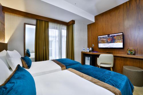 Postel nebo postele na pokoji v ubytování The Tango Hotel Taksim