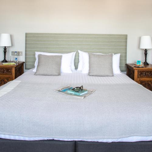 a bed with a pair of glasses on it at The Porlock Weir Hotel in Porlock