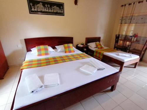 A bed or beds in a room at Green Land Guest House