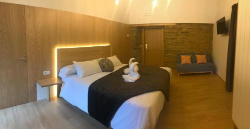 a bedroom with a bed with a stuffed animal on it at A Casa da Botica in Samos