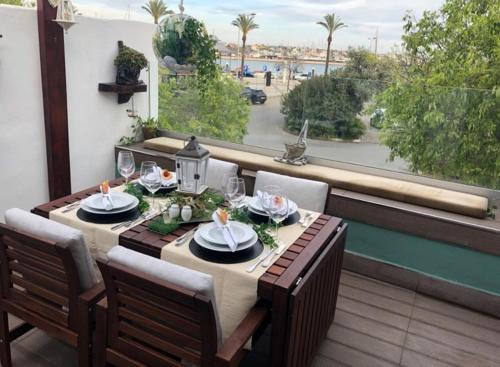 a dining table with a view of the ocean at Villa Rio Guest House Suites in Portimão