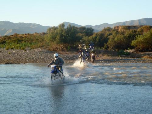 a group of people riding horses in the water at Gîte Raid Oriental in Taforhalt