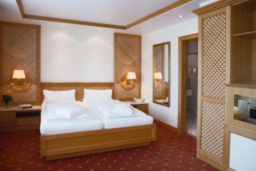 a hotel room with a bed and a fireplace at Thermenhotel Quellenhof in Bad Füssing