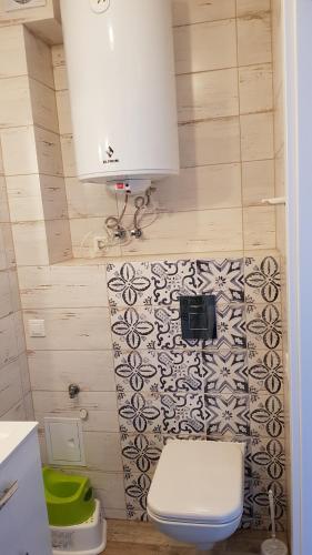 a small bathroom with a toilet and a sink at Apartament Baltic Relax in Rowy