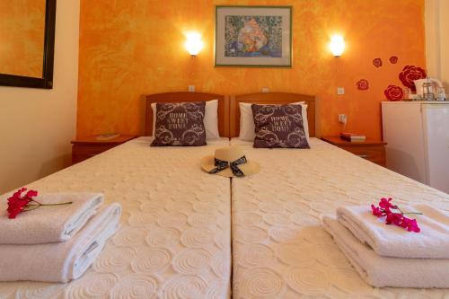 a bedroom with a large bed with a hat and towels at Villa Litsa in Ermones
