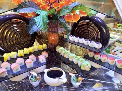 a display of sushi and plates on a table at Abha Palace Hotel in Abha