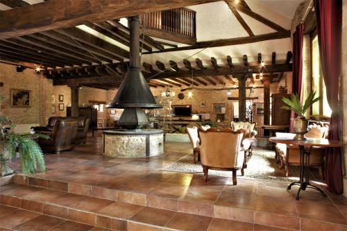 a living room with a fireplace and a table and chairs at Domaine de Vareilles in Vareilles